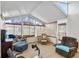 Bright sunroom featuring large windows, tile flooring, and comfortable seating, perfect for relaxation at 4925 Cedarstone Ln, Orlando, FL 32822