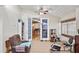 Inviting sunroom featuring tile flooring, ceiling fan, and views of the adjacent dining area and backyard at 4925 Cedarstone Ln, Orlando, FL 32822