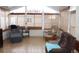 Bright sunroom with large windows, tile flooring, and comfortable seating, perfect for relaxation at 4925 Cedarstone Ln, Orlando, FL 32822