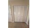 White sliding door closet with built-in shelving at 528 Cadiz Loop, Davenport, FL 33837