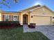 Charming single-story home featuring a well-manicured lawn and a welcoming front entrance at 528 Cadiz Loop, Davenport, FL 33837