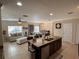 Open-concept living space with kitchen island, adjacent to a dining area and living room, perfect for entertaining at 528 Cadiz Loop, Davenport, FL 33837