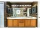 Bathroom with wood cabinets, dual sinks, white countertop, black medicine cabinets and glass enclosed shower in view at 723 Long Lake Dr, Oviedo, FL 32765
