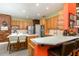 Bright kitchen with wood cabinets, tiled backsplash, white countertop, island, barstool seating, and stainless steel appliances at 723 Long Lake Dr, Oviedo, FL 32765