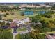 Stunning aerial view of golf course with a beautiful clubhouse, green fairways, and a serene lake at 1379 Kiawah St, Celebration, FL 34747