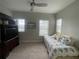Cozy bedroom with a twin bed, large entertainment center and plenty of natural light from the bright windows at 1379 Kiawah St, Celebration, FL 34747