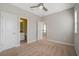 Clean bedroom featuring neutral carpet, an ensuite bathroom, and a view into the upstairs landing at 1379 Kiawah St, Celebration, FL 34747