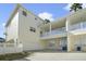 Rear exterior view of a multi-story home featuring a garage, a private balcony and white trim at 1379 Kiawah St, Celebration, FL 34747