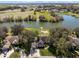 Aerial view of the property with a lake view, a private dock, and a well-manicured lawn at 1845 Farrington Dr, Lakeland, FL 33809