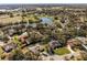 Expansive aerial view showcasing the community, lakes, and lush greenery of the surrounding area at 1845 Farrington Dr, Lakeland, FL 33809