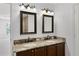 Bathroom featuring double sinks with granite countertops and dark wood cabinetry at 1845 Farrington Dr, Lakeland, FL 33809