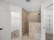 Bathroom featuring a tiled shower and a walk-in closet with wire shelving at 1845 Farrington Dr, Lakeland, FL 33809