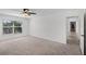 Bright bedroom with neutral carpet, ceiling fan and plenty of natural light at 1845 Farrington Dr, Lakeland, FL 33809