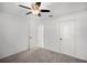 Bedroom with carpet, ceiling fan and two doors at 1845 Farrington Dr, Lakeland, FL 33809