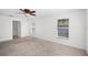 Bright bedroom with neutral carpet, ceiling fan, and two windows at 1845 Farrington Dr, Lakeland, FL 33809