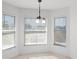 Bright breakfast nook featuring three windows, neutral walls and floors, and modern light fixture at 1845 Farrington Dr, Lakeland, FL 33809