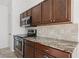 Modern kitchen with stainless steel appliances and dark wood cabinetry at 1845 Farrington Dr, Lakeland, FL 33809