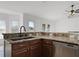 Granite kitchen counters with a stainless steel dishwasher and stainless steel sink and faucet at 1845 Farrington Dr, Lakeland, FL 33809