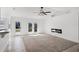 Bright living room with fireplace, ceiling fan and sliding glass doors to outdoor view at 1845 Farrington Dr, Lakeland, FL 33809