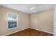 Cozy bedroom with wood-look floors and a ceiling fan, perfect for a relaxing retreat at 2441 Derby Dr, Deltona, FL 32738