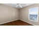 This cozy bedroom features laminate flooring, a ceiling fan, and a bright window at 2441 Derby Dr, Deltona, FL 32738