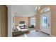 Bright living room with stylish decor, ample seating, and plenty of natural light from large windows at 2441 Derby Dr, Deltona, FL 32738