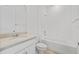 Bright bathroom featuring white subway tile in the bath and shower with a granite vanity at 2740 Sweet Acacia Dr, Clermont, FL 34711