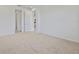 Spacious carpeted bedroom features neutral colors, ample natural light, and a view of the entrance to the home at 2740 Sweet Acacia Dr, Clermont, FL 34711