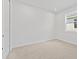 Bright bedroom features neutral colors and ample natural light, with a view of the side yard through a window at 2740 Sweet Acacia Dr, Clermont, FL 34711