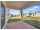 Covered patio overlooking a spacious backyard, perfect for outdoor entertaining and relaxation at 2740 Sweet Acacia Dr, Clermont, FL 34711