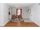 Dining area with a modern table set and view of front door entry and galley kitchen at 2913 Joyann St, Orlando, FL 32810
