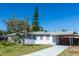 Charming single-story home with a well-maintained lawn and a convenient carport, exuding curb appeal and comfort at 2913 Joyann St, Orlando, FL 32810