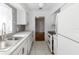 Bright kitchen features white cabinets, modern appliances, and stylish gray backsplash at 2913 Joyann St, Orlando, FL 32810