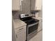 Updated kitchen features stainless steel appliances and white cabinetry at 2913 Joyann St, Orlando, FL 32810