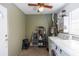 Functional laundry room with washer, dryer, water heater, and plenty of room for laundry tasks and storage at 2913 Joyann St, Orlando, FL 32810