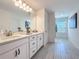 Elegant bathroom featuring double sinks, granite countertops, and modern tile flooring at 678 Fiddlesticks Dr, Davenport, FL 33837