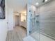 Modern bathroom showcasing a glass-enclosed shower, tile flooring, and a vanity with ample counter space at 678 Fiddlesticks Dr, Davenport, FL 33837