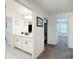 Hallway with double sink bathroom featuring white cabinets and decor at 678 Fiddlesticks Dr, Davenport, FL 33837