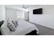 Airy bedroom featuring natural light, a comfy bed, and a wall-mounted TV at 678 Fiddlesticks Dr, Davenport, FL 33837