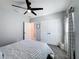 Cozy bedroom features a ceiling fan, double closet, and a neutral color scheme at 678 Fiddlesticks Dr, Davenport, FL 33837