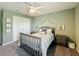 Comfortable bedroom with a ceiling fan, carpet, and a double door closet for storage at 678 Fiddlesticks Dr, Davenport, FL 33837