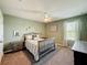 Cozy bedroom featuring a bed, nightstands, carpet, and a ceiling fan for added comfort at 678 Fiddlesticks Dr, Davenport, FL 33837