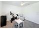Bright bonus room featuring a Peloton exercise bike, ceiling fan, and neutral decor at 678 Fiddlesticks Dr, Davenport, FL 33837