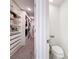 Organized walk-in closet with custom shelving and drawers, plus a toilet tucked away for added convenience at 678 Fiddlesticks Dr, Davenport, FL 33837