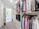 Large walk-in closet with custom organizers, shelves, and hanging space, leading to the bathroom at 678 Fiddlesticks Dr, Davenport, FL 33837