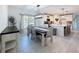 Bright dining room showcasing an elegant table and an open view of the modern kitchen at 678 Fiddlesticks Dr, Davenport, FL 33837