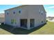 Rear exterior view of home with a covered patio and green lawn at 678 Fiddlesticks Dr, Davenport, FL 33837