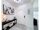 Welcoming foyer featuring light tile floors and a modern console table with stylish decor at 678 Fiddlesticks Dr, Davenport, FL 33837