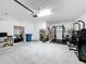 Garage features a clean, open space with storage, work-out space and ample lighting at 678 Fiddlesticks Dr, Davenport, FL 33837