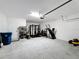 Bright garage with storage shelves, workout area, and door to outside at 678 Fiddlesticks Dr, Davenport, FL 33837